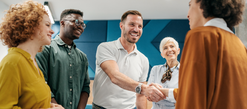 Group of new hires shaking hands